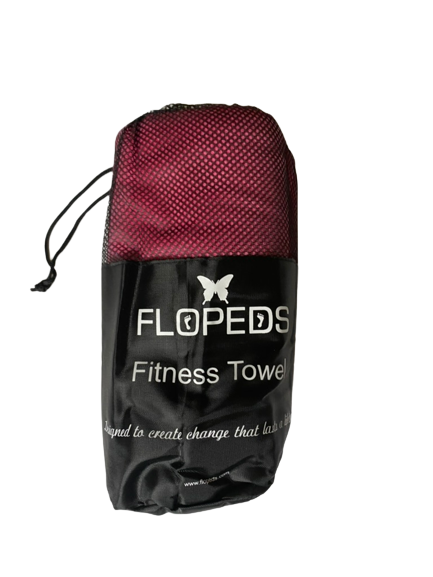 A red Fitness Towel by FLOPEDS, packaged in a Fitness Tower, with a logo and a butterfly graphic on the front. The towel is described as a 'Small' size on the product packaging.